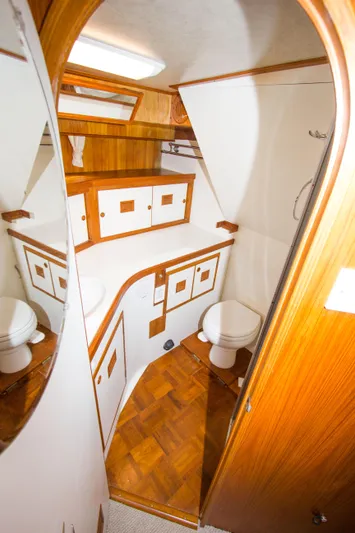 Seascape Yacht Photos Pics 1989 Cheoy Lee 53 yacht bathroom with wooden cabinetry and modern fixtures.