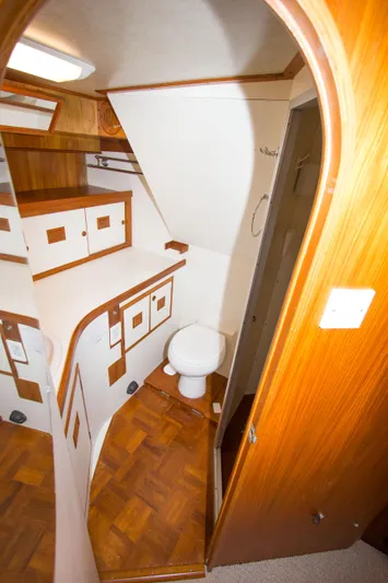 Seascape Yacht Photos Pics 1989 Cheoy Lee 53 yacht interior with wooden cabinetry and compact bathroom.