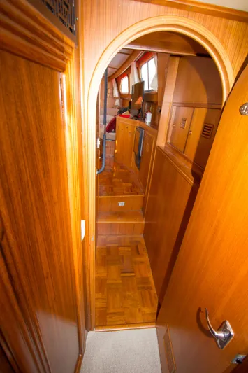 Seascape Yacht Photos Pics Interior view of 1989 Cheoy Lee 53 yacht with wooden finishes and arched doorway.