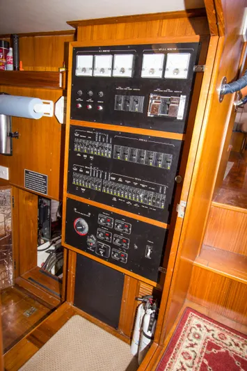 Seascape Yacht Photos Pics Electrical control panel on a 1989 Cheoy Lee 53 yacht, featuring gauges and switches.