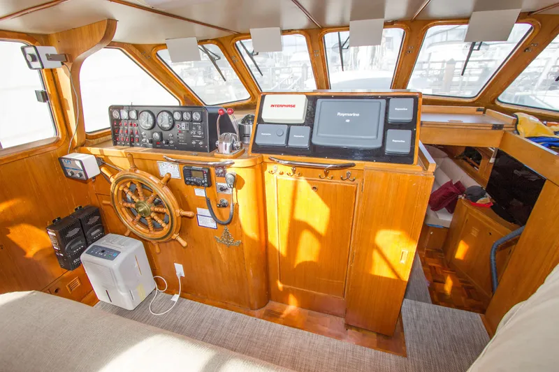 Seascape Yacht Photos Pics 1989 Cheoy Lee 53 yacht helm with wooden steering wheel and navigation instruments.