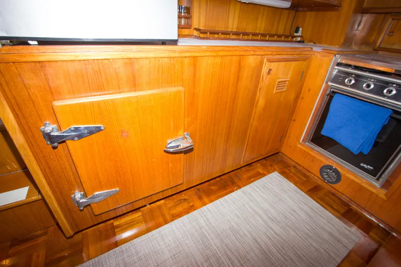 Seascape Yacht Photos Pics Wooden kitchen interior of 1989 Cheoy Lee 53 yacht with oven and storage.