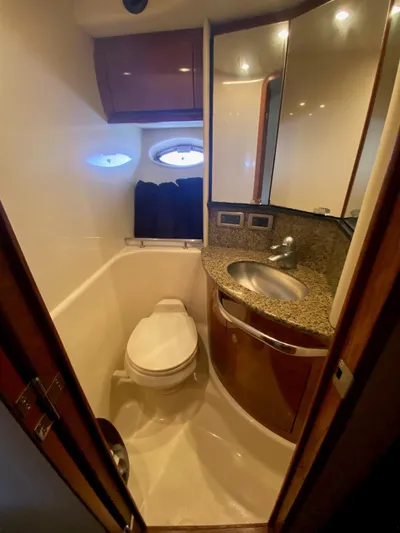  Yacht Photos Pics 2006 Sea Ray 44 Sundancer yacht bathroom with sink, toilet, and porthole windows.