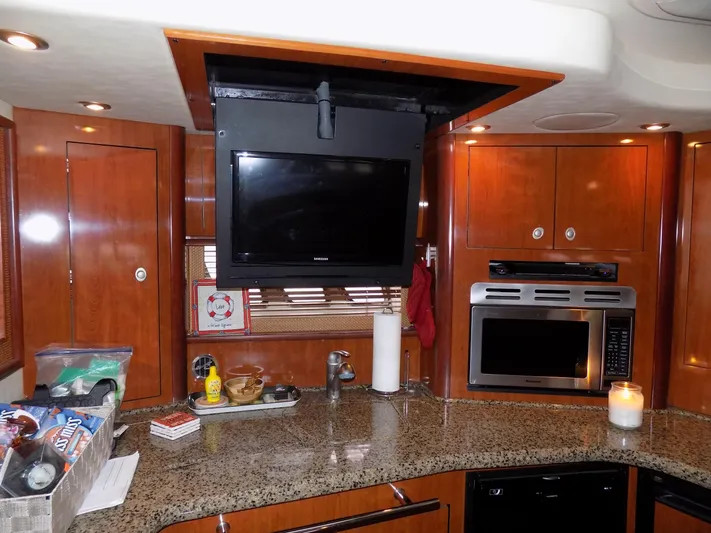  Yacht Photos Pics Interior kitchen of 2006 Sea Ray 44 Sundancer yacht with TV and modern appliances.