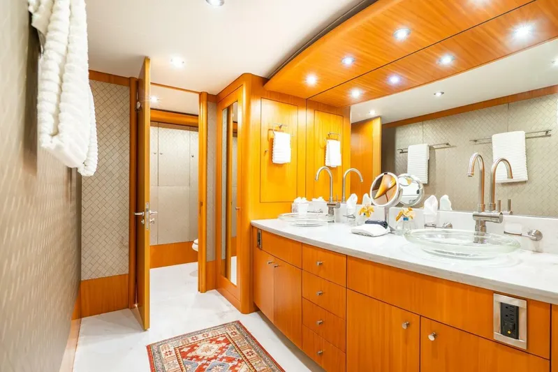 Serenity Yacht Photos Pics Luxurious bathroom in 2008 Lazzara Motor Yacht with wooden cabinetry and modern fixtures.