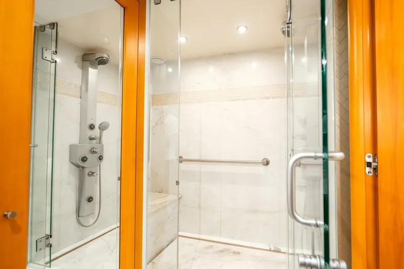 Serenity Yacht Photos Pics Luxurious shower in 2008 Lazzara Motor Yacht with glass doors and modern fixtures.
