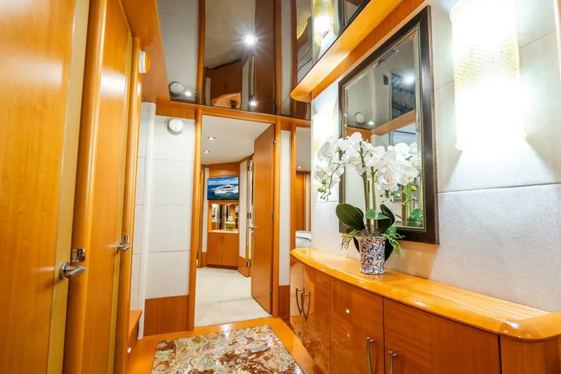 Serenity Yacht Photos Pics Luxurious interior of a 2008 Lazzara motor yacht with elegant wood finishes and floral decor.