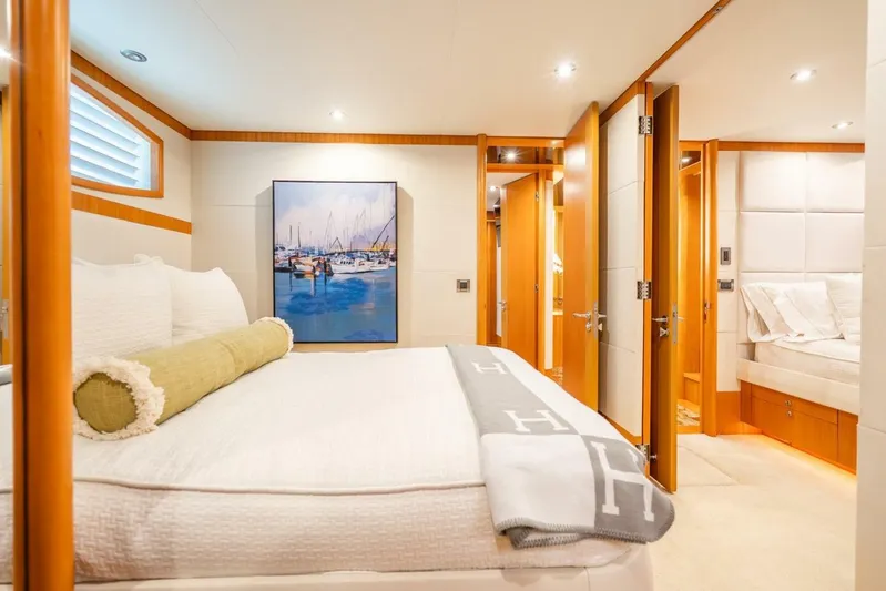 Serenity Yacht Photos Pics Luxurious bedroom interior of 2008 Lazzara Motor Yacht with elegant decor and cozy bedding.