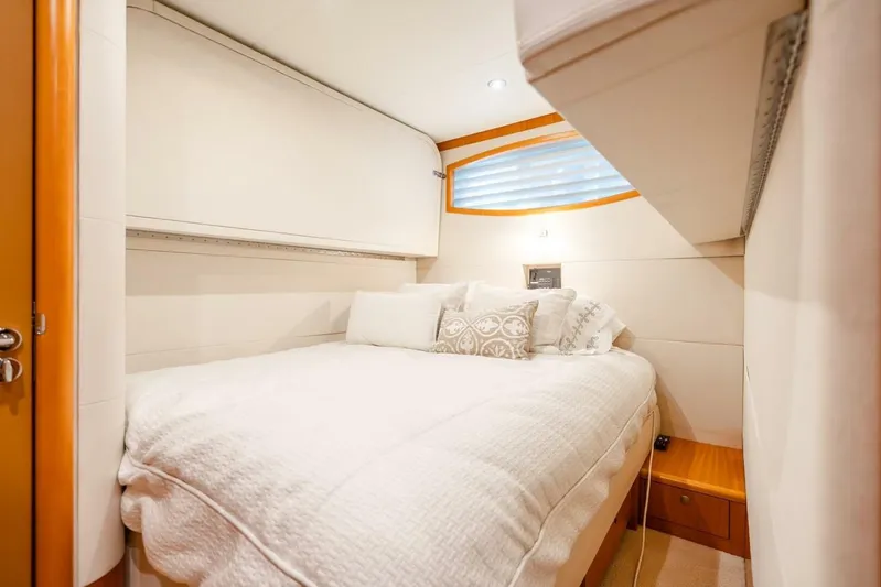 Serenity Yacht Photos Pics Luxurious bedroom interior of 2008 Lazzara Motor Yacht with elegant bedding and soft lighting.