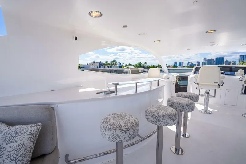 Serenity Yacht Photos Pics Luxurious 2008 Lazzara Motor Yacht deck with bar stools and city skyline view.