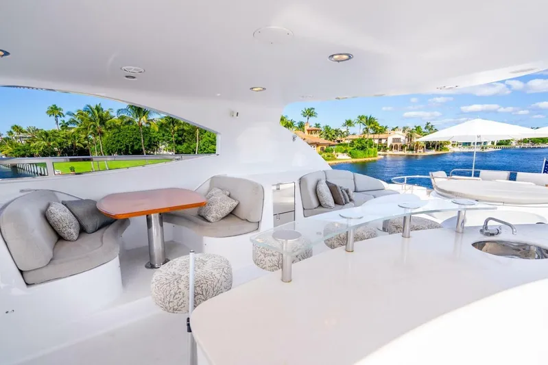 Serenity Yacht Photos Pics Luxurious 2008 Lazzara Motor Yacht deck with elegant seating and scenic waterfront view.