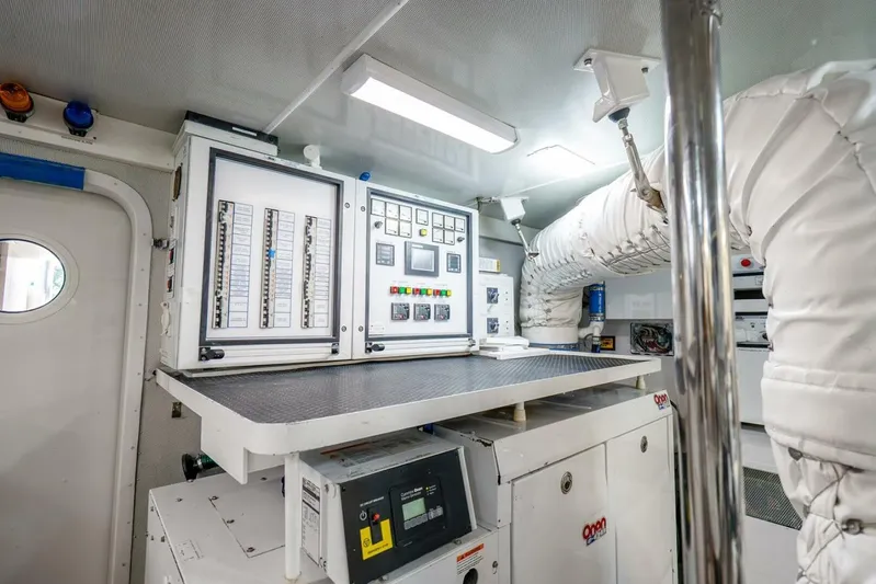 Serenity Yacht Photos Pics Engine room of a 2008 Lazzara Motor Yacht with control panels and equipment.