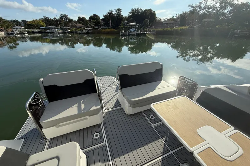  Yacht Photos Pics Aquila 32 Sport 2021 boat deck with seating and table on calm water.