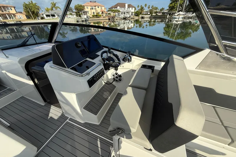  Yacht Photos Pics 2021 Aquila 32 Sport boat interior with modern helm and seating.