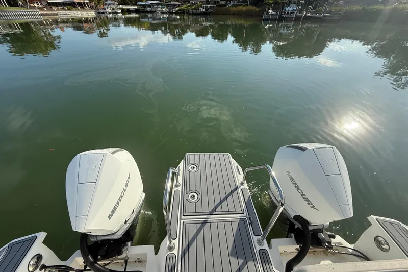  Yacht Photos Pics Aquila 32 Sport 2021 boat with dual Mercury engines on a calm lake.