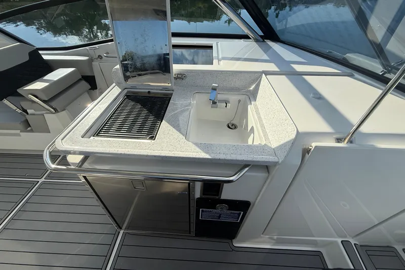  Yacht Photos Pics Aquila 32 Sport 2021 boat interior with sink and grill station.