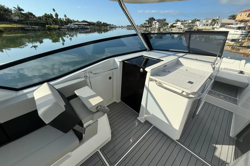  Yacht Photos Pics 2021 Aquila 32 Sport boat interior with sleek seating and modern dashboard.