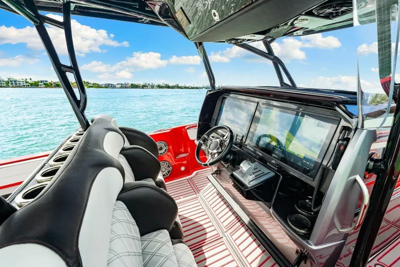  Yacht Photos Pics 2022 Nor-Tech 390 SS boat interior with modern dashboard and luxurious seating.