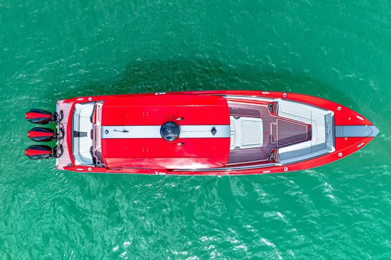  Yacht Photos Pics Aerial view of 2022 Nor-Tech 390 SS boat in vibrant red on turquoise water.