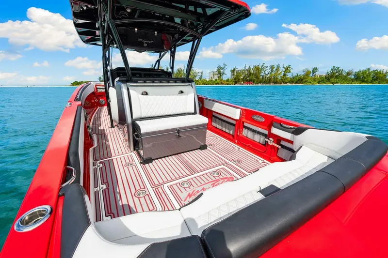  Yacht Photos Pics 2022 Nor-Tech 390 SS boat with red and white interior on clear blue water.