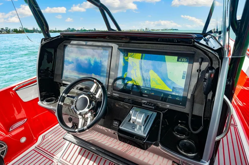  Yacht Photos Pics 2022 Nor-Tech 390 SS boat dashboard with advanced navigation screens and sleek steering wheel.