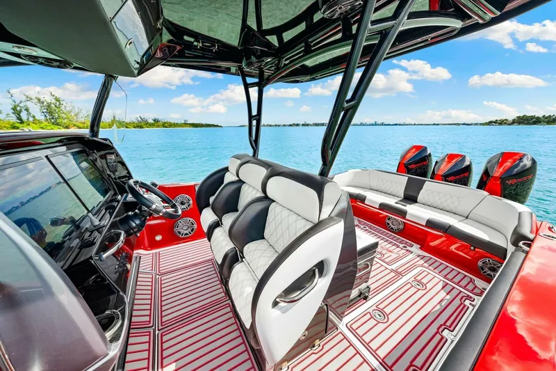  Yacht Photos Pics 2022 Nor-Tech 390 SS boat interior with luxurious seating and multiple engines on a sunny day.