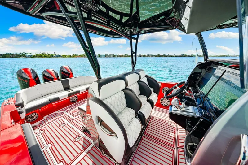  Yacht Photos Pics 2022 Nor-Tech 390 SS boat interior with luxurious seating and advanced controls on a sunny day.