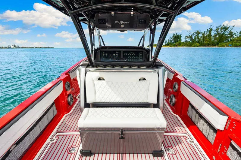  Yacht Photos Pics 2022 Nor-Tech 390 SS boat interior with red accents, white seating, and ocean view.