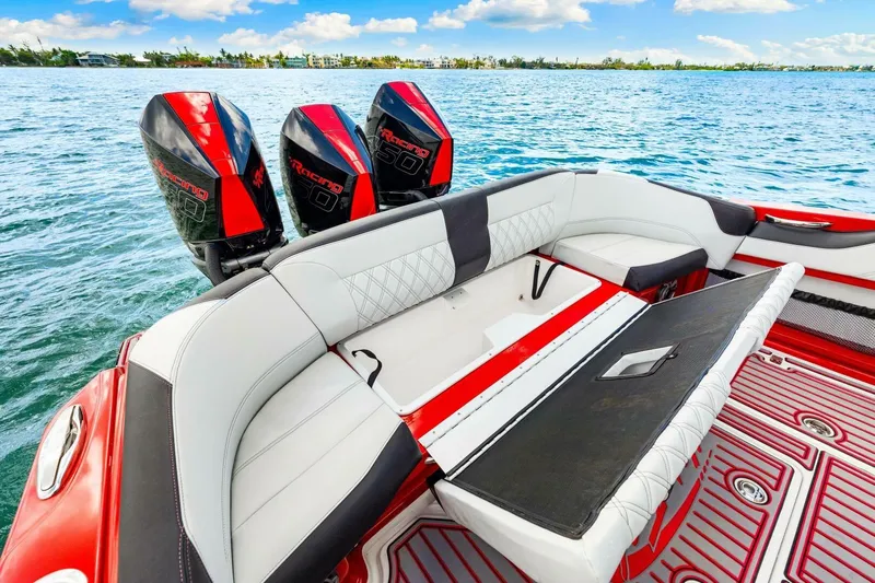  Yacht Photos Pics 2022 Nor-Tech 390 SS boat with triple outboard engines, luxurious seating, and vibrant red accents.