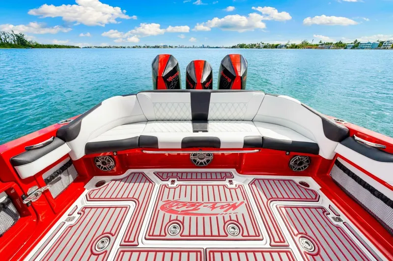  Yacht Photos Pics Luxurious 2022 Nor-Tech 390 SS boat interior with red and white seating, on a serene water backdrop.