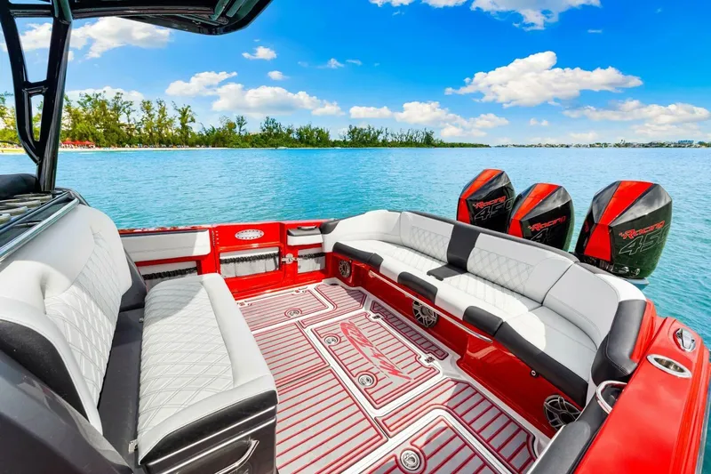 Yacht Photos Pics 2022 Nor-Tech 390 SS boat interior with luxurious seating and powerful engines on a serene lake.