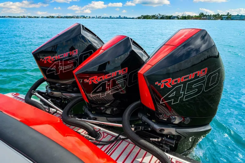  Yacht Photos Pics Triple Mercury Racing 450 engines on a 2022 Nor-Tech 390 SS boat in clear blue water.