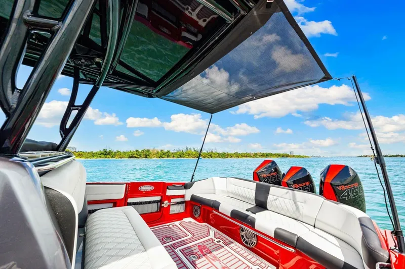  Yacht Photos Pics 2022 Nor-Tech 390 SS boat interior with luxurious seating and powerful engines on a sunny day.