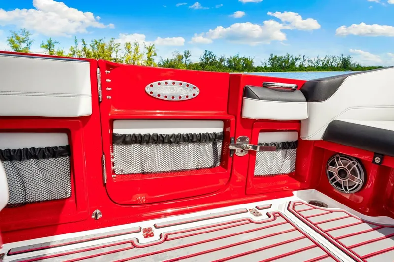  Yacht Photos Pics 2022 Nor-Tech 390 SS boat interior with red accents and seating, under a blue sky.