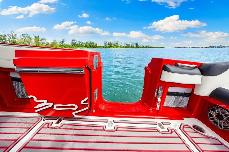  Yacht Photos Pics 2022 Nor-Tech 390 SS boat interior with red accents, open water view, and clear blue sky.