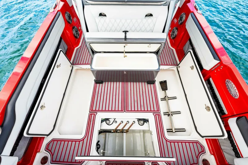  Yacht Photos Pics 2022 Nor-Tech 390 SS boat interior with red accents and storage compartments.