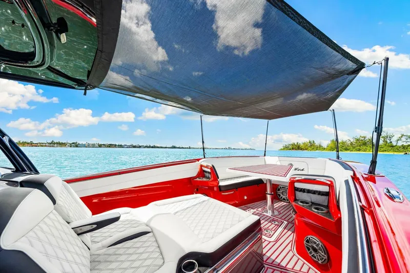  Yacht Photos Pics 2022 Nor-Tech 390 SS boat interior with luxurious seating and sunshade on a sunny day.