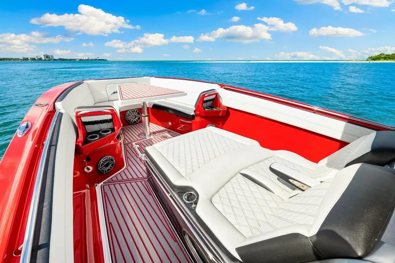  Yacht Photos Pics 2022 Nor-Tech 390 SS boat interior with red and white seating, on a sunny day at sea.