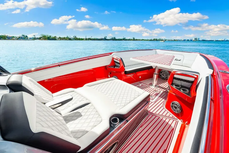 Yacht Photos Pics Luxurious 2022 Nor-Tech 390 SS boat interior with red and white seating, on a sunny day.