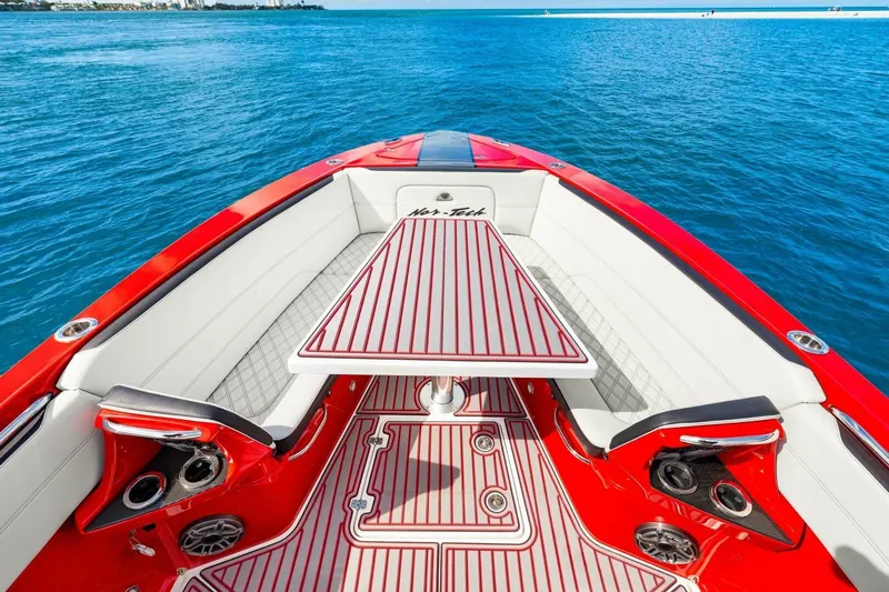  Yacht Photos Pics 2022 Nor-Tech 390 SS boat interior with red and white seating, table, and ocean view.