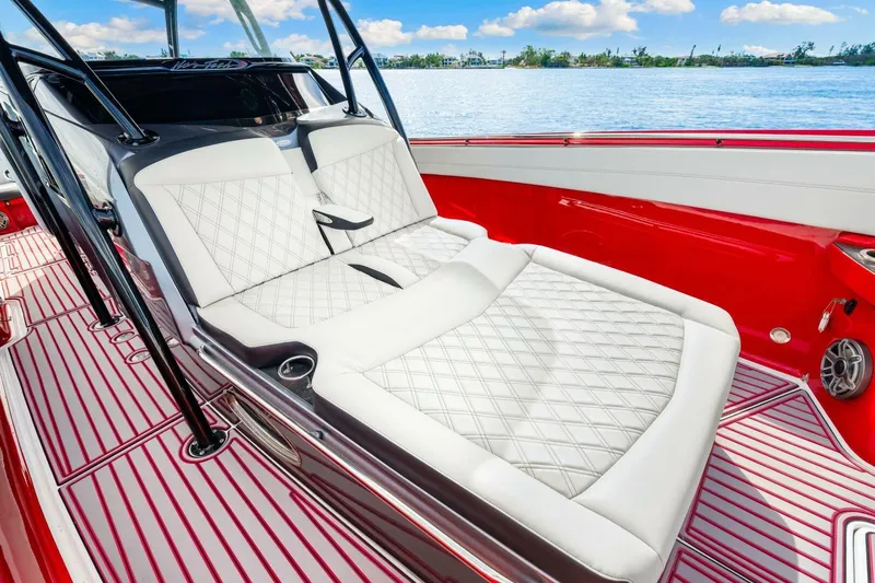  Yacht Photos Pics Luxurious interior of 2022 Nor-Tech 390 SS boat with white quilted seating and red accents.