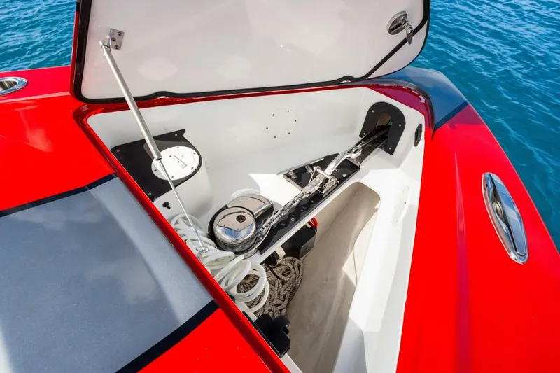  Yacht Photos Pics Open anchor compartment of 2022 Nor-Tech 390 SS boat, featuring red and gray exterior.