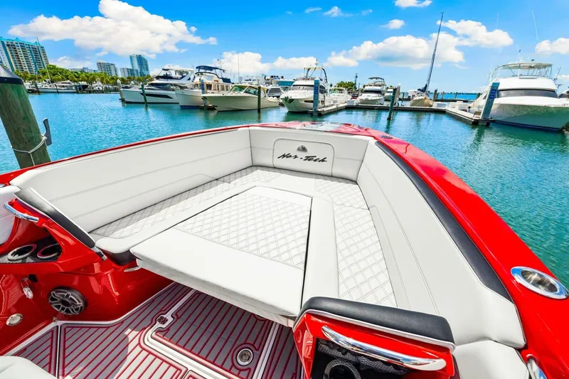  Yacht Photos Pics 2022 Nor-Tech 390 SS boat with luxurious seating in a marina setting.