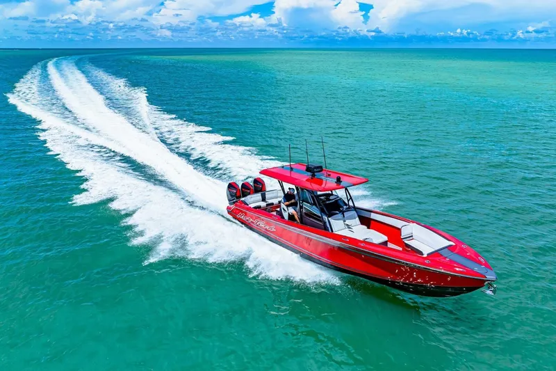  Yacht Photos Pics Red 2022 Nor-Tech 390 SS speedboat cruising on turquoise ocean waters.