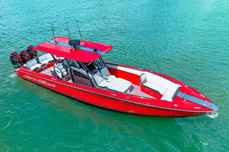  Yacht Photos Pics 2022 Nor-Tech 390 SS boat in vibrant red on clear blue water.