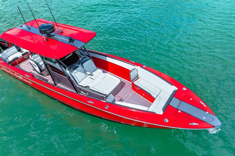  Yacht Photos Pics Red 2022 Nor-Tech 390 SS boat on clear blue water, featuring sleek design and spacious seating.