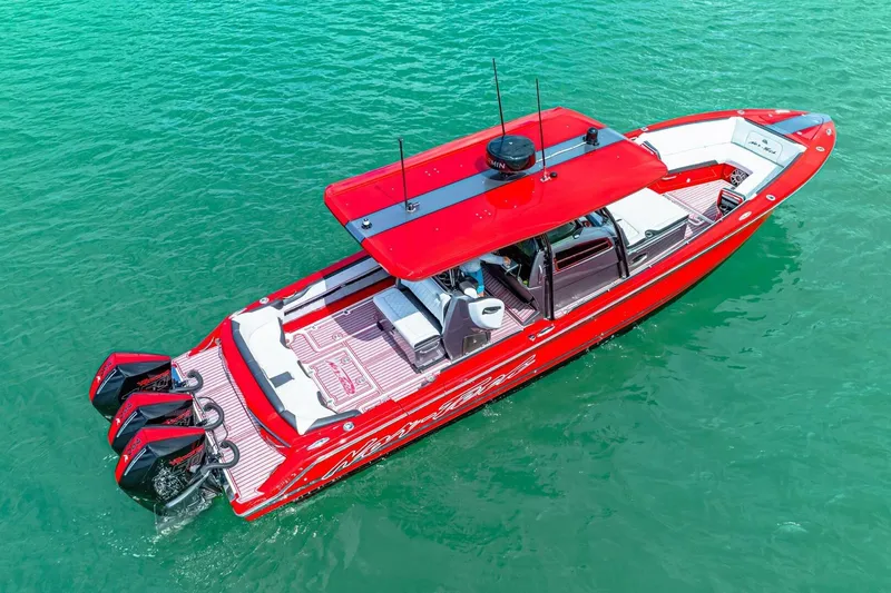  Yacht Photos Pics Red 2022 Nor-Tech 390 SS boat on clear turquoise water, aerial view.