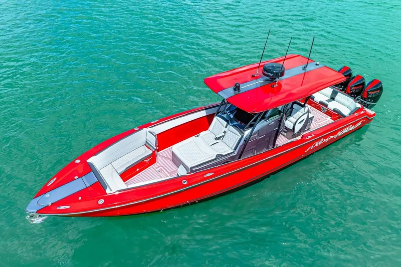  Yacht Photos Pics 2022 Nor-Tech 390 SS boat in vibrant red on clear blue water.