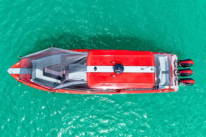  Yacht Photos Pics Aerial view of 2022 Nor-Tech 390 SS boat on turquoise water.