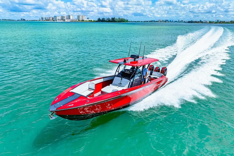  Yacht Photos Pics 2022 Nor-Tech 390 SS speedboat cruising on turquoise water under a blue sky.